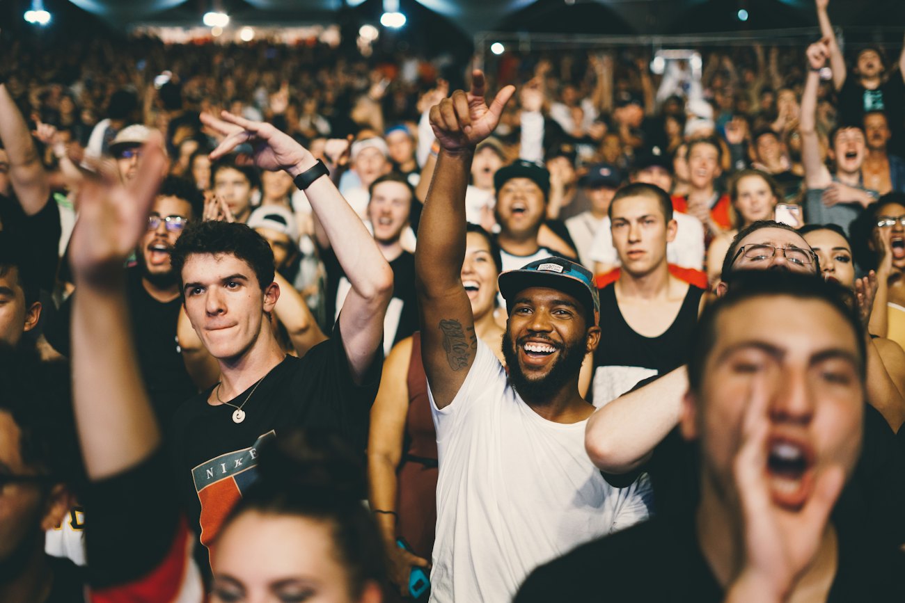 A crowd cheering at a live concert